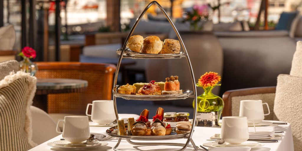 Elegant afternoon tea stand with savoury bites, scones and pastries in a luxury Cape Town hotel