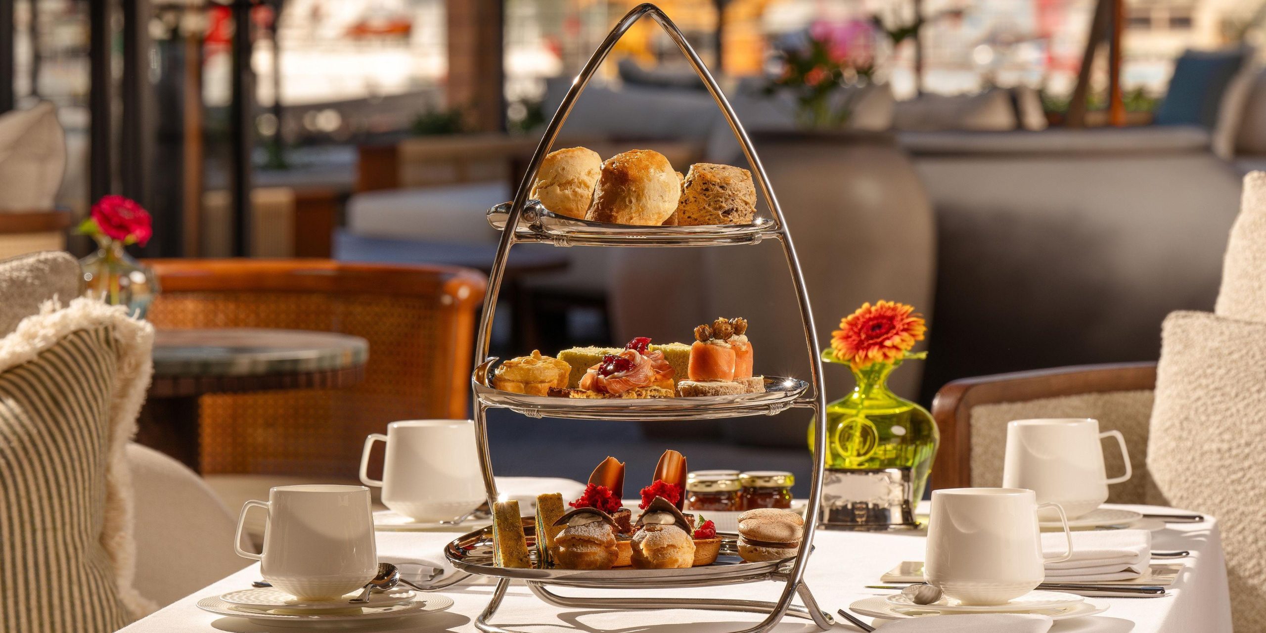 Elegant afternoon tea stand with savoury bites, scones and pastries in a luxury Cape Town hotel